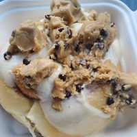 Roll with cream cheese frosting and cookie dough. The employee put on gloves to pull the dough apart. I suggest they invest in a scoop . at Cinnaholic in Seattle