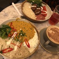 Peanut butter and sweet potato Dhall, hot chocolate with oat milk, charitea and falafel bowl.  at Vertigo - Cross St in Manchester