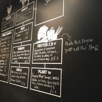 The wall at the entrance clearly shows all the vegan options. at Honest Burgers in London