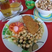 Main plate is salad, garbanzo beans and breaded mock meat. Also included is a big fruit salad, drink and fruit dessert, all for 9 soles in January 2020 at Frutal  in Lima