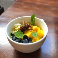 Brown rice, hot turmeric milk, mango, berries, coconut, almonds, dates at Big Love Juice in Bellingham