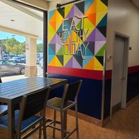 Seating and wall art at Wrapway in Charlotte