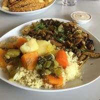 Shawarma on a plate with hot couscous  at Hummus Bar in Haifa