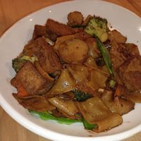 Hunan stir fries chow fun noodles with tofu at GingeRootz Asian Grille in Appleton