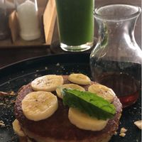 Pancakes with caramelised banana (requested vegan) and green juice  at Cafe Kumbuk in Colombo