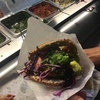 Falafel "sandwhich" pits with falafels, add your own toppings from the extensive toppings bar with an extensive amount of vegan options.  at Amsterdam Falafelshop in Miami