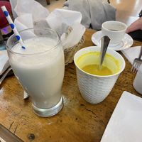 Banana shake w almond milk (⚠️might have cross contamination 🥜) 6/10 and golden milk 7/10  at Aadha-Aadha Café in Varanasi