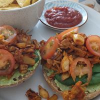 Pulled jackfruit sandwich with tortilla chips and salsa on the side at Fast & Vegan in The Hague