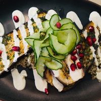 
Aubergine Chermoula
Slow roasted eggplant on quinoa with chermoula sauce, pomegranate, cucumber salad and lime dressing at Stem & Glory in London