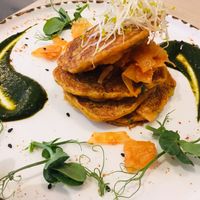 Kimchi Pancakes with daikon pickle salad, dehydrated black olive salt, nasturtium leaf + jang sauce at Stem & Glory in London