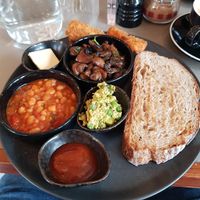 Vegan Breakfast: Vegan butter, hash browns, mushrooms, beans, smashed peas, sourdough toast, homemade ketchup jam. at Chi Chi's in North London