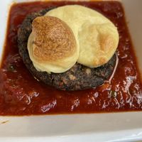 Q-Ball with puttanesca sauce topped with vegan cashew cheese at Mezzo Italiano in Cambria