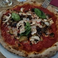 Vegan pizza: marinara with vegetables and vegan mozzarella on top at Simbiosi in Florence