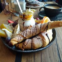 Sweet breakfast with croissants, fruits, margarine, nuts, various spreads and soy yoghurt. at Veg room in Berlin