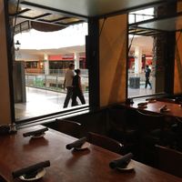 Tables by windows that open to the mall at CRAVE in Bloomington