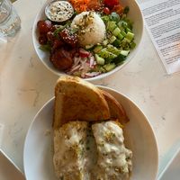 Buffalo Cauliflower Salad above and cheesy Lasagna below with bread.   at Community Restaurant in Oakville