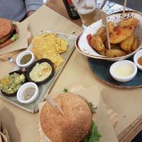 Burger with tapas and fries on the side at Veggie Burger by Biocenter in Barcelona
