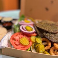 MUNCHY BOX
2 sides of seitan kebab, 1 side of meatballs, 2 sides of french fries, 8 onion rings, 1 side of falafel, hummus, mixed salad, BBQ sauce, cheese sauce, tzatziki and 2 pi at Vegan Community Kitchen in Apex