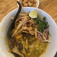 The Khao Soi is a standout, a Northern Thai curry noodle dish with a rich yellow curry broth, king trumpet mushrooms, chili jam, crispy noodles, red onion, pickled mustard greens  at Uncle in Denver