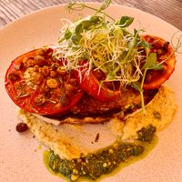 Toast with grilled tomatoes, crispy chickpeas, sprouts, hummus and pesto.  at Alberta's in Mapua