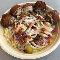 Basmati rice bowl with falafel, chopped salad, purple cabbage, sumac onions, Naf pickles, tahini & lemon vinaigrette (vegan). Free pita not showing. at Naf Naf Grill in Eagan