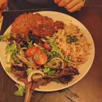 Fish with tomato rice and salad at Kong - Food Made With Compassion in Lisbon