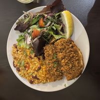 Fish with tomato rice and salad  at Kong - Food Made With Compassion in Lisbon