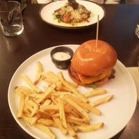 Vegan burger in front and vegan octopus dish in the back  at Kong - Food Made With Compassion in Lisbon