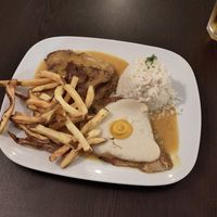 Seitan steak with rice and potatoe fries and a sunny side up, served with a special mustard sauce at Kong - Food Made With Compassion in Lisbon