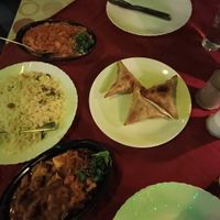 Mushroom masala (top left), tofu rajma (kidney bean) curry (bottom left) and yellow coconut rice. Vegetable samosa. at Suprabhatham in Kovalam