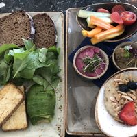 Veganarrisch (rye bread, avocado, chard, tofu, veggies, 2 dips, porridge) at Cafe Drechsler in Vienna