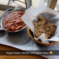 Vegan butter chicken and warm toasted garlic naan. SO GOOD! at The Pizza Castle and Indian Curry in Vancouver