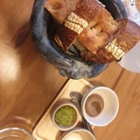 Sourdough bread, focaccia, cashew cream, cashew cream with black garlic and pesto at Arkhe in Lisbon