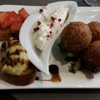 A welcome surprise: an amuse bouche of mini toasts and "accras," deep fried balls of goodness with a creamy dipping sauce. at Utopia in Nice