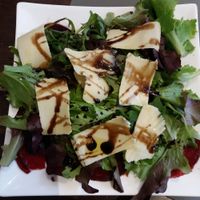 First course: Beet carpaccio topped with greens,  balsamic vinaigrette, and sharp cheese. at Utopia in Nice