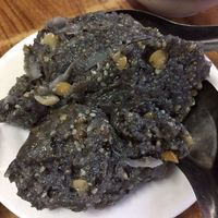 A dessert made from sticky rice and sesame, eaten with palm sugat at Sein Than Htay in Mandalay