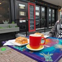 Exterior of Lotus Bleu. Note the dog water bowls, handicap accessible entrance, and the window planters with vegetables and herbs. at Lotus Bleu Cafe in Edmundston