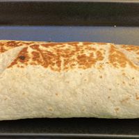 One bite I to the breakfast burrito with tofu scramble, veggie sausage, and no cheese. at The Hummingbird Cafe in Butte