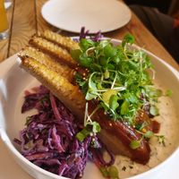 Smoked rib of corn with sticky bourbon glaze, a red cabbage slaw, a beautiful creamy ranch dressing, topped with watercress at The Roundhill in Brighton