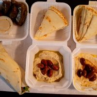 Dolmades (grape leaves), baba ganoush, hummus, and falafel sandwich. Fit for royalty. at Sophi's Mediterranean Cafe & Market in Biloxi