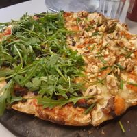 Half Franzini pizza (mozzarella, tomato sauce, argula, tapenade, parmesan), half Alonso pizza (mozzarella, baked sweet-potato, blue cheese, wallnuts, chives). All vegan of course at Pizza Posta in Madrid