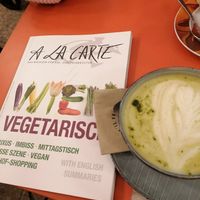 Matcha latte and vegetarian book at Plain in Vienna