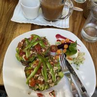Toast with avo, pesto, tomato and jalapeño and above iced latte with coconut milk   at Elephant Garden in Puerto Escondido