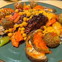 Mixed vegan dish with purple rice, chickpeas, falafel, and roast veggies. at Soup in Town in Lucca