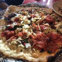 Vegan pizza! Feed three people!!!! Topped with tomato sauce, olives, artichokes, onions, kale, red peppers, and vegan cheese at Avalon - Woodward Ave in Detroit
