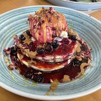 Pancakes with berries with extra almond butter on top  at WAVE in East London
