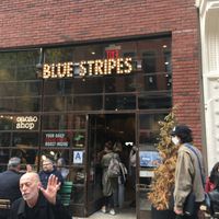 Front entrance, plus outdoor seating. at Blue Stripes Cacao Shop in New York City