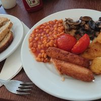 Full Vegan Breakfast - Vegan sausage, baked beans, whole fried tomato, hash browns, mushrooms, served with vegan toast and vegan spread. at Twisted Currant in Helston