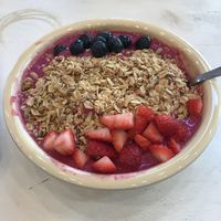 Mother of Dragons smoothie bowl with strawberries, blueberries and granola. Had it made with their oat milk instead of juice. So delicious! at Good Life Organics in Shillington
