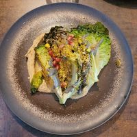 Starter: Hummus, roasted sucrine lettuce, black sesame cream, white pepper, pomegranate seeds and roasted pistachio. at Le Potager de Charlotte - Rennequin in Paris